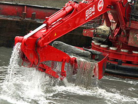 Spudleg backhoe dredger in action